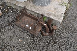 A vintage cast boot scraper and two cobblers lasts