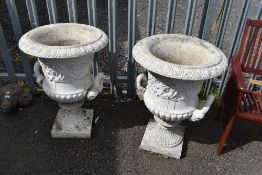 A pair of concrete garden urns in the classical style