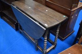 An early to mid 20th Century dark oak gateleg dining table