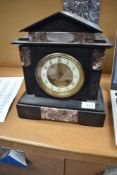 A Victorian black slate mantel clock having engraved white metal plaque for 1889 and brass centre