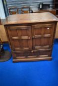 A modern Ercol mid stain bookcase TV cabinet