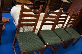 A set of four modern oak ladder back dining chairs having upholstered seats