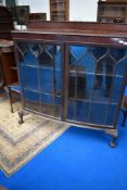 An early 20th Century mahogany bow front china cabinet on ball and claw feet, width approx 123cm