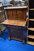 A 19th Century walnut Davenport style desk having fitted cupboard top, pull out desk section and