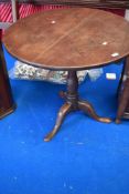 A 19th Century mahogany pedestal table having circular top with birdcage support on turned column