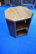An early 20th Century oak occasional table with bookshelf under