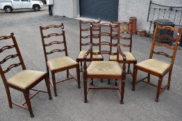 A set of six (five plus one) mahogany dining chairs having shaped ladder back and later