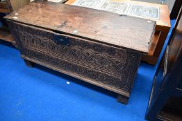 A period oak coffer having carved panel to front, width approx. 113cm