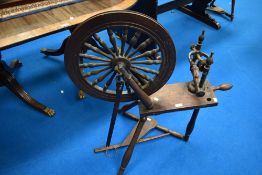 A 19th century spinning wheel, with notch carved block, turned supports and rails, the wheel with