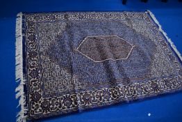 A machine loomed Sennah design rug with central lozenge enclosed by foliate motif filled ground,