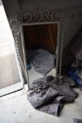 A vintage wrought metal wall mirror