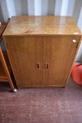 A vintage golden oak record cabinet