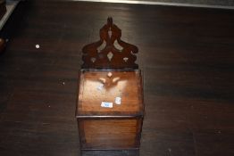 A late 19th century mahogany candle box, having carved back and inlaid detailing to lid and front.