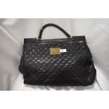 A quilted black leather handbag or larger proportions, bearing the Dolce and Gabbana label to