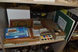 An array of vintage and modern craft and artists supplies, including watercolour paints, brushes,
