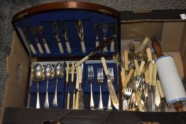 An early 20th century mahogany canteen containing plated knives and forks with bone handles and