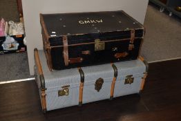 A vintage steamer trunk and a large case having GMKW to lid, with leather handles and edging.