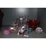 A small collection of Caithness and similar paperweights and vases, and a Victorian ruby glass vase