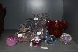A small collection of Caithness and similar paperweights and vases, and a Victorian ruby glass vase