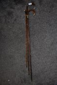 Three antique bamboo walking canes, including some with hallmarked silver cuffs of detail to