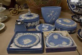 An assortment of blue and white Wedgwood Jasperware, including large trinket boxes, desk top lighter