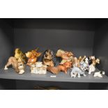 An assortment of ceramic and chalkware dog studies, including Wade Lady and the Tramp whimsies.