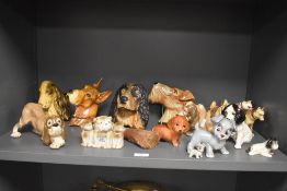 An assortment of ceramic and chalkware dog studies, including Wade Lady and the Tramp whimsies.