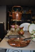 A vintage copper kettle, a copper griddle, a brass trivet on stand and more.
