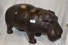 A leather covered model of a baby Hippopotamus with inset glass eyes, the leather covering nicely