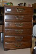 A set of six vintage drawers of small proportions, having brass handles.