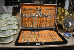A vintage canteen of stainless steel cutlery with moulded handles.