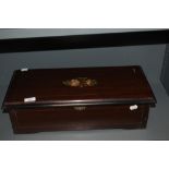 A 19th Century mahogany cased music box, having 8 airs, the pictorial card having hand written