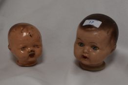 Two vintage cast-composite dolls heads, painted with wear