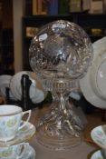 A crystal table lamp, having spherical shade with etched floral decoration, in the manner of
