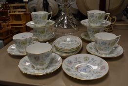A collection of Minton 'Vanessa' cups and saucers and three small plates.