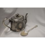 A silver plated tea pot having decorative finial and a tablespoon having embossed fruit pattern.