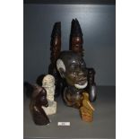 A selection of African carved wood and natural stone busts.