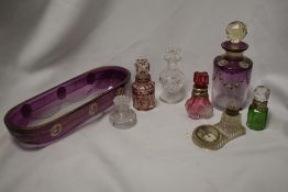 A variety of vintage and antique glassware, including souvenir ink well, perfume bottles, some
