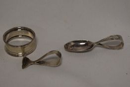 A silver babies feeding spoon and sugar push, together with a silver napkin ring