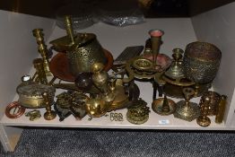 An assortment of vintage and antique brass and copper, including copper bull rings, trivets,