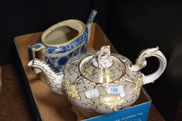 A Victorian Rockingham style teapot, having grey and yellow pattern with gilt heightening and an