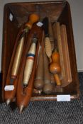 A vintage wooden trug housing a selection of bobbin shuttles, peggy rug making tools and crochet