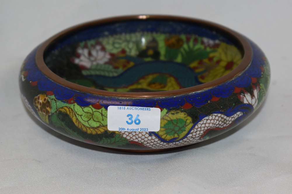 A 20th century cloisonné on copper shallow bowl, having dragon and flower design to centre.