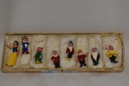 A set of cast and painted lead 'Snow White and the Seven Dwarfs' figures, housed in a sectioned card