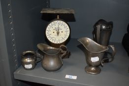 An early 20th century Salter letter balance and four plated jugs.