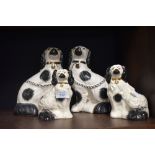 A pair of fireside staffordshire dogs and a pair of similar smaller size