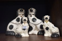 A pair of fireside staffordshire dogs and a pair of similar smaller size