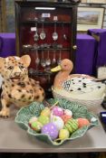 A wooden display case with a selection of collectable teaspoons, a leopard cub animal study, a