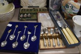 A small selection of flatware including boxed teaspoons and bone handled knives.