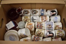 An assortment of celebration and commemorative ware including Royal Doulton and Mason's, two red art